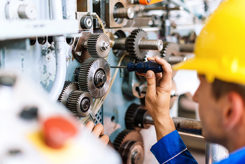 Machinist Precisely Setting Up Cog Wheels